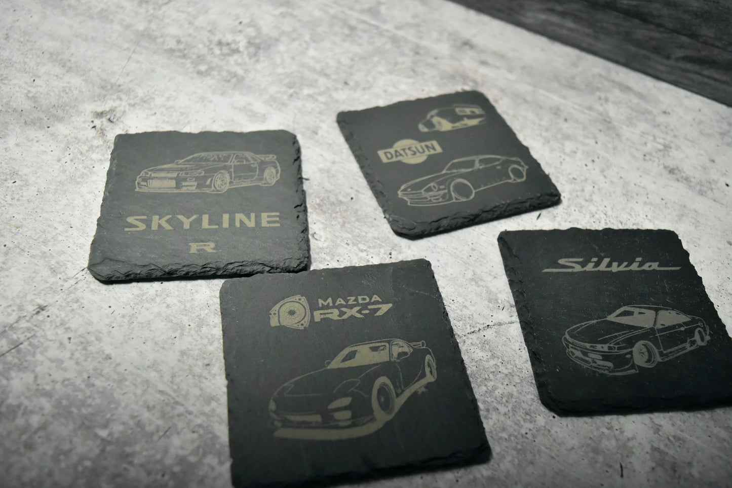 set of custom engraved slate coasters featuring jdm cars including rx7 skyline gtr 240sx silvia and datsun 240z
